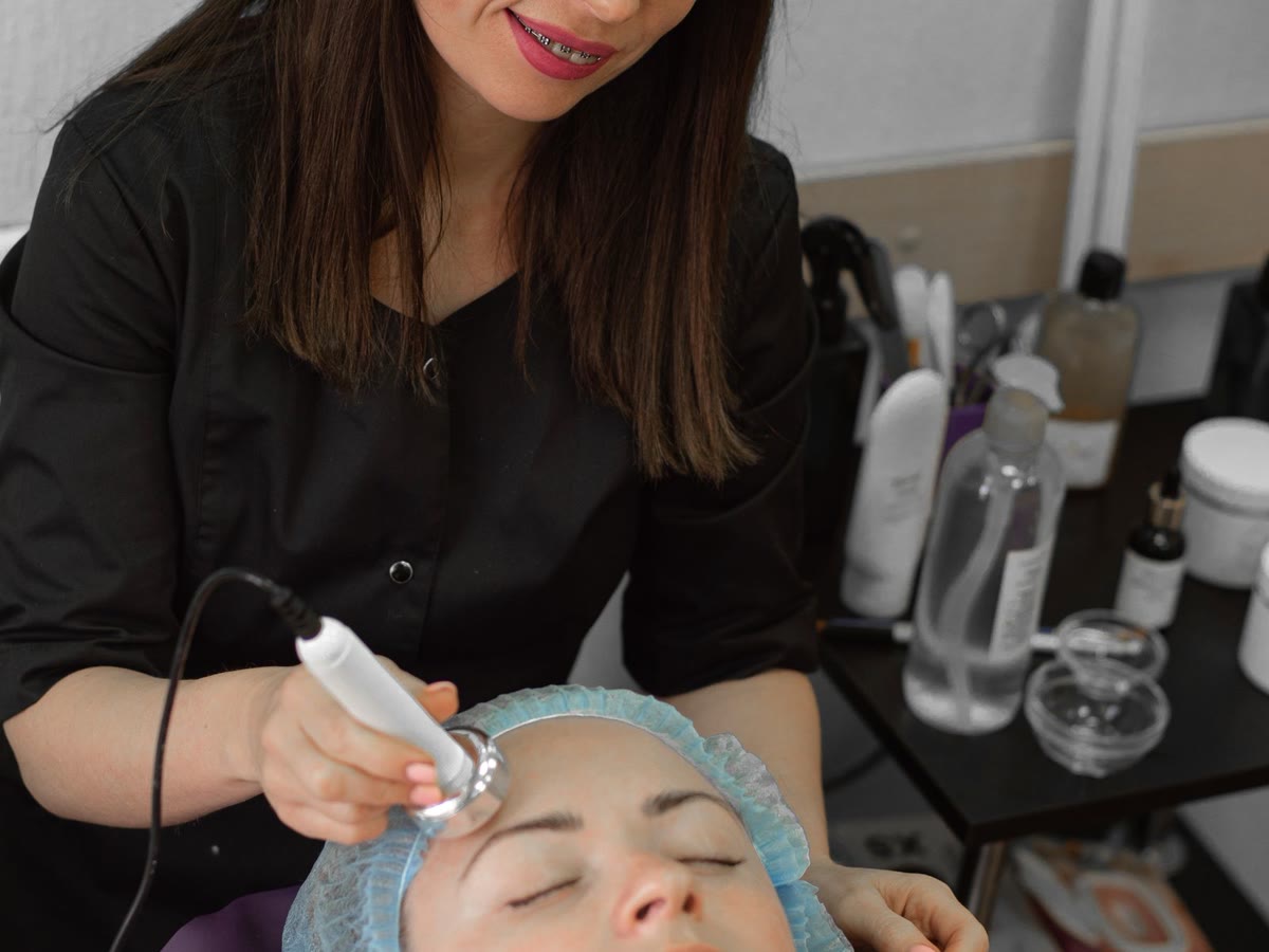 Beautician applying a facial treatment in a private treatment room
